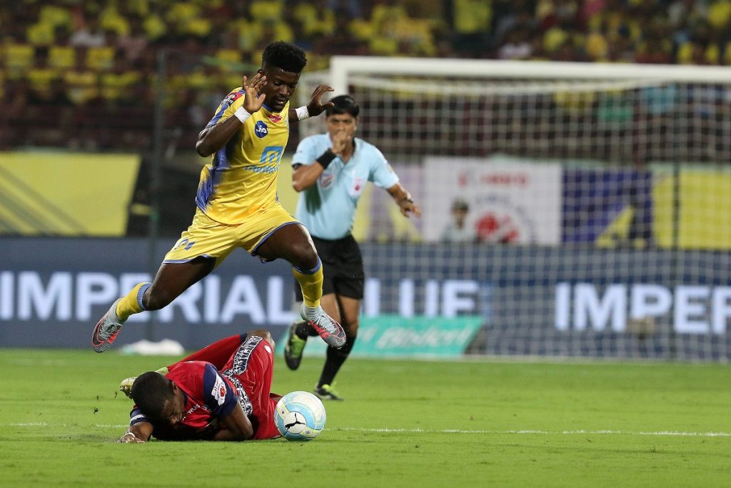 Courage Pekuson of Kerala Blasters FC jumps over Trindade of Jamshedpur FC during match 7 of the Hero Indian Super League between Kerala Blasters FC and Jamshedpur FC held at the Jawaharlal Nehru Stadium,Kochi India on the 24th November 2017. (Photo credit: ISL)